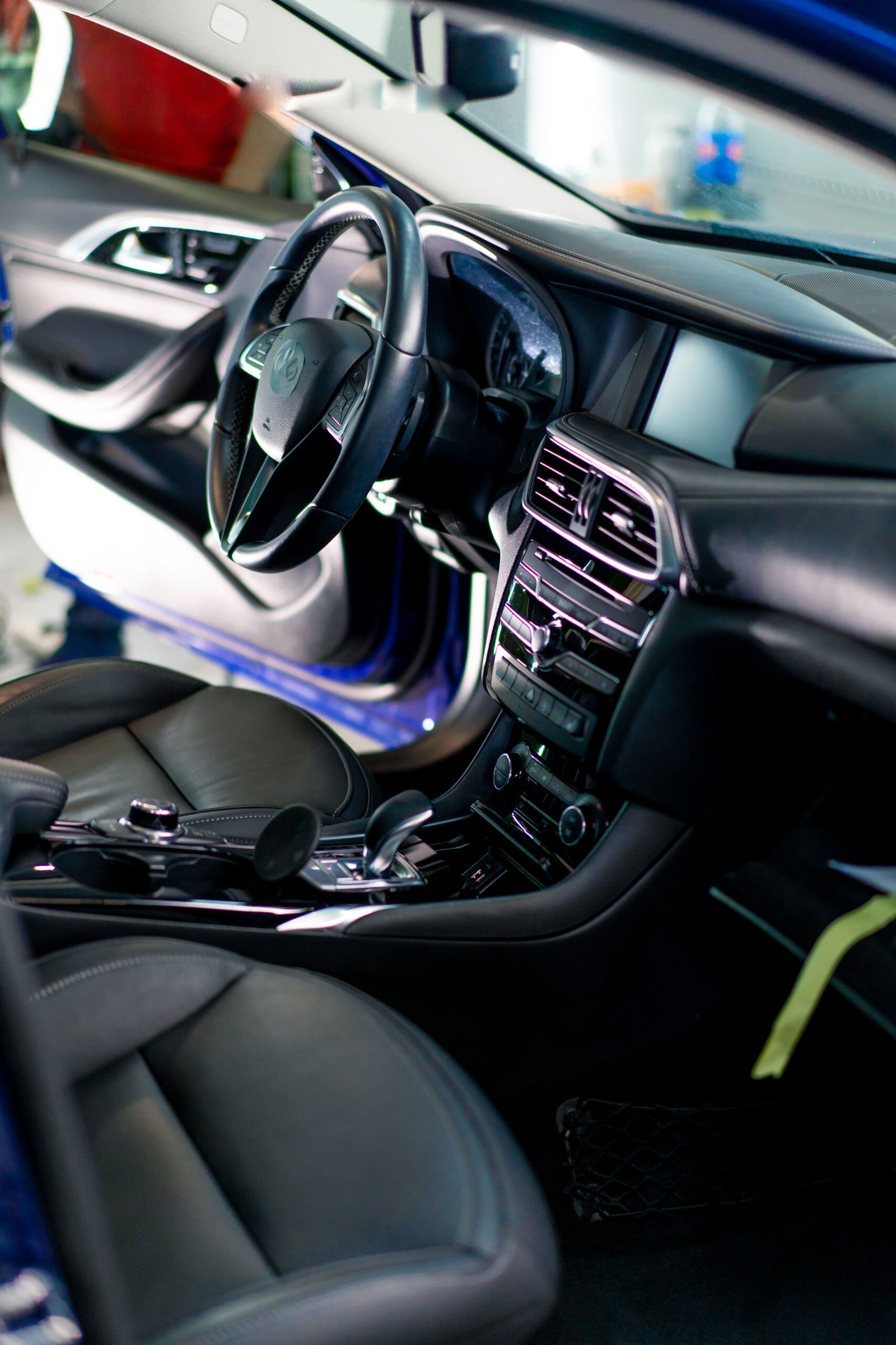 Close-up of the steering wheel of a luxury car with black interior after dry cleaning and washing detailing
